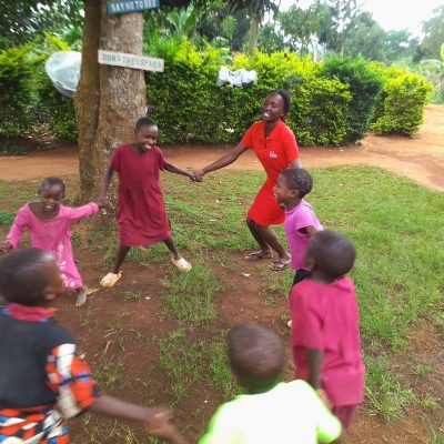 Sserinya primary school children play with teacher